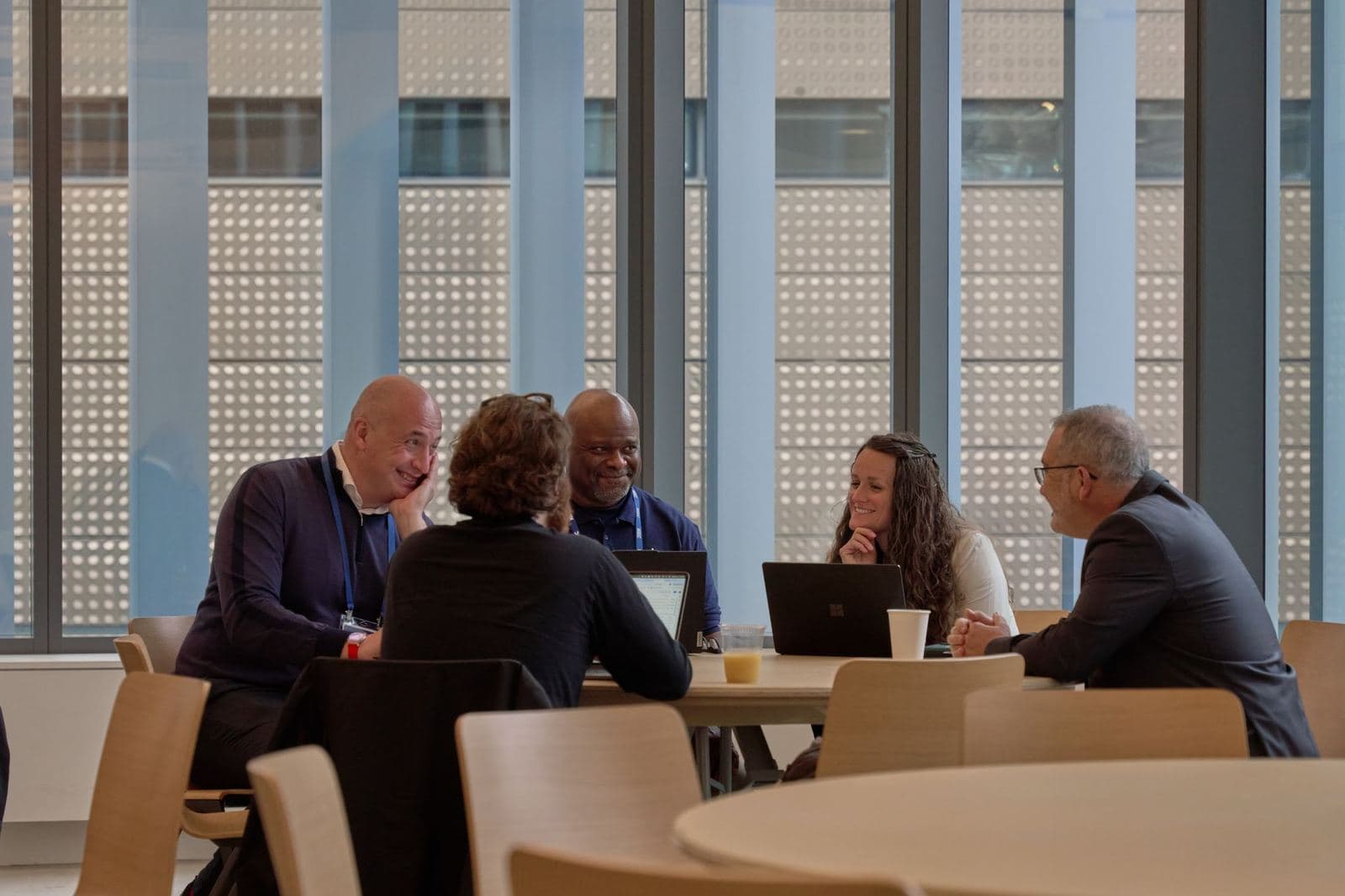 Small groups meeting at tables by the windows at KGC 2025